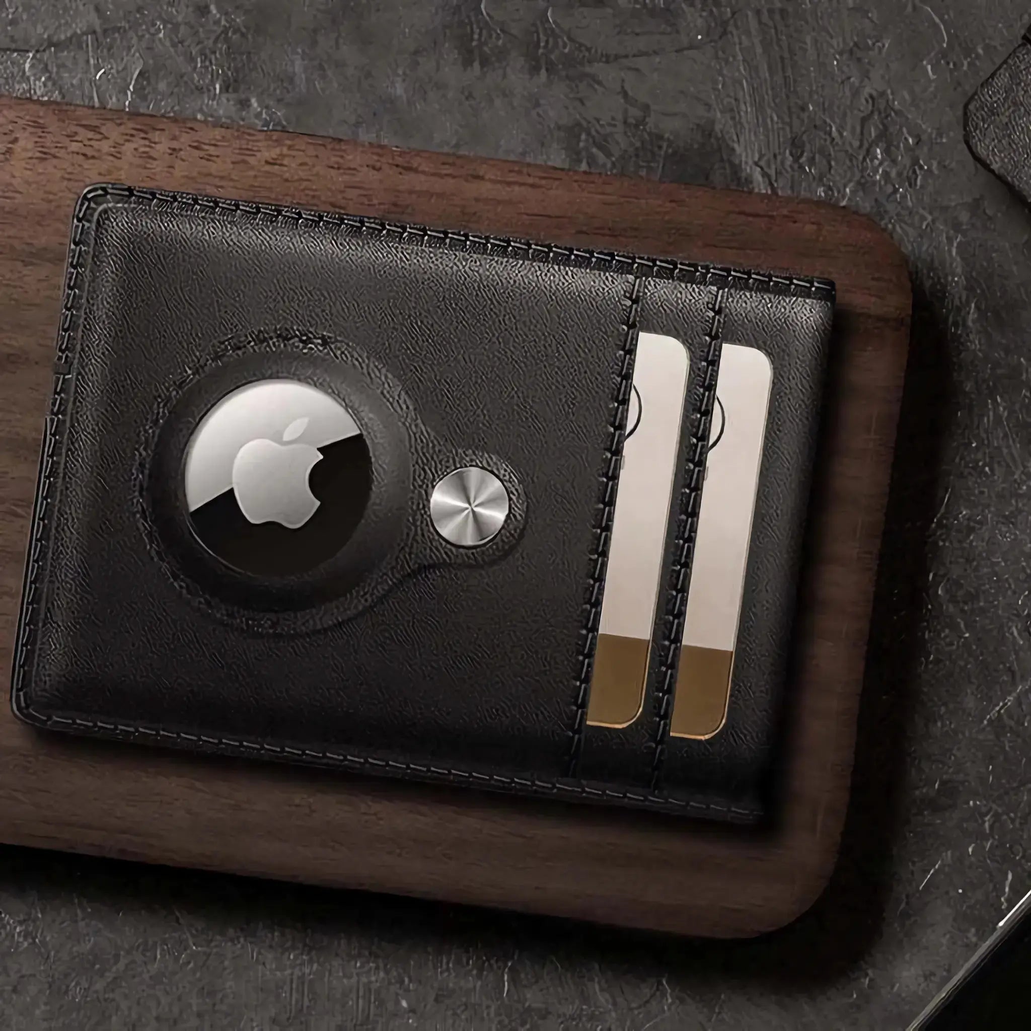 Minimify Bifold AirTag Wallet in Midnight Black leather holding gold-edged cards on table